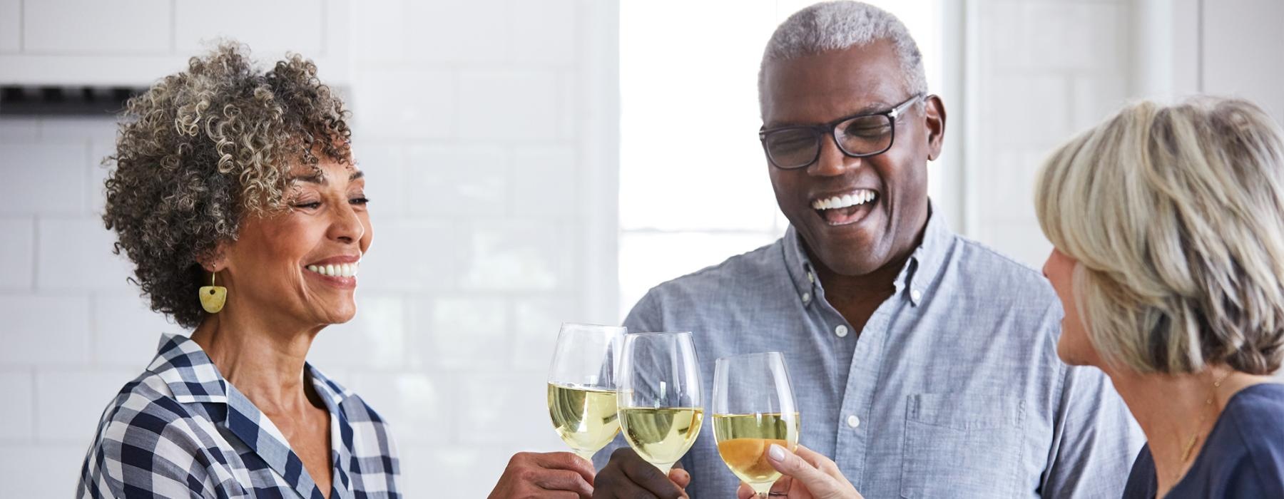 a few people toasting wine glasses